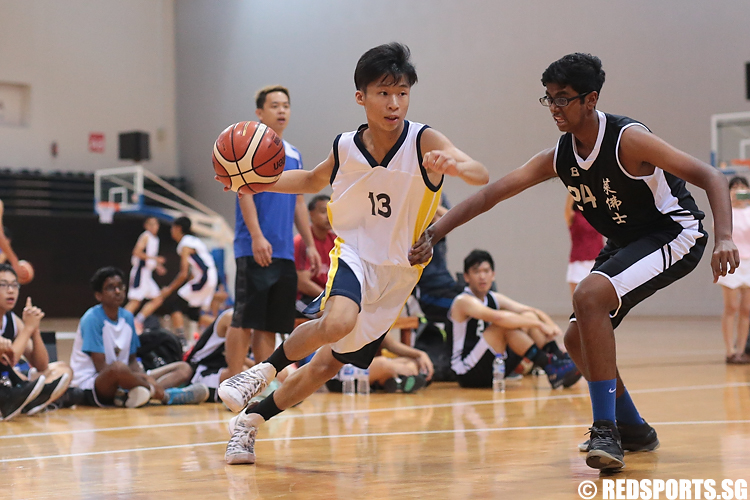 Marcus Kok (#13) of Guangyang Secondary drives against Arjun Kumanan (#24) of Raffles Institution. (Photo 5 © Lee Jian Wei/Red Sports)