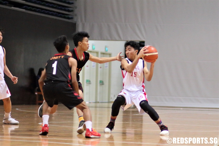 Panca (ACSB #15) protects the ball as he finds himself double-teamed. (Photo © Chan Hua Zheng/Red Sports)