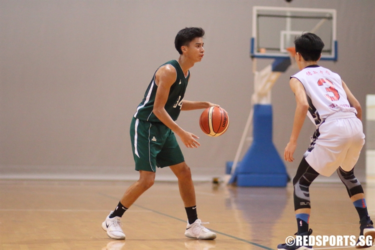 Pan Ming Hui (CHR #34) sizes up the defense as he looks to drive. He finished with a team-high 11 points. (Photo © Chan Hua Zheng/Red Sports)
