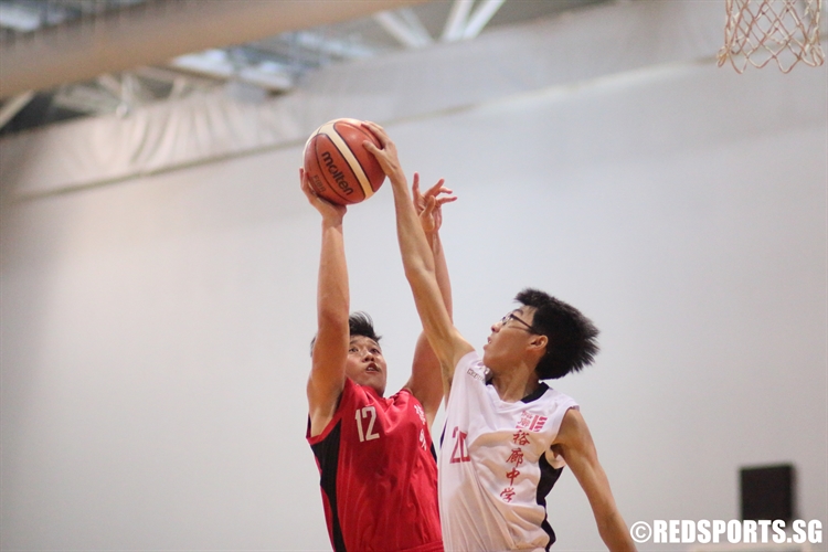 Brandon (Jurong #20) gets a clean rejection on John Ng (Dunman #12). (Photo 7 © Dylan Chua/Red Sports)