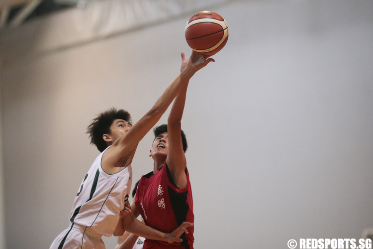 Brendon Hao (#35) of Christ Church Secondary and Bryan Yong (#10) of Dunman Secondary fights for the rebound. (Photo © Lee Jian Wei/Red Sports)