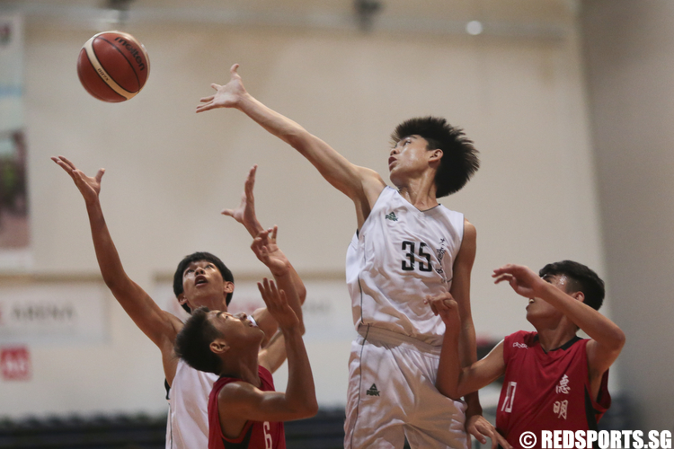 Brendon Hao (#35) of Christ Church Secondary fights for the rebound against Dunman Secondary. (Photo © Lee Jian Wei/Red Sports)