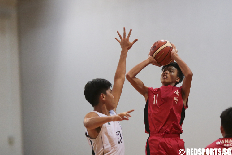 Moses Peh (#11) of Dunman Secondary shoots against Yeo Yuan Jun (#33) of Christ Church Secondary. (Photo © Lee Jian Wei/Red Sports)