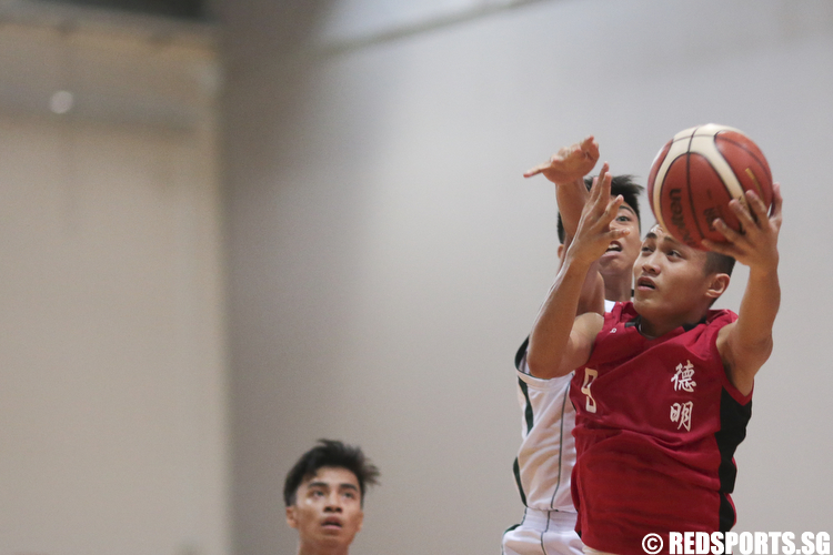 Israel Liam (#9) of Dunman Secondary shoots against Rafael Gian (#22) of Christ Church Secondary. (Photo © Lee Jian Wei/Red Sports)