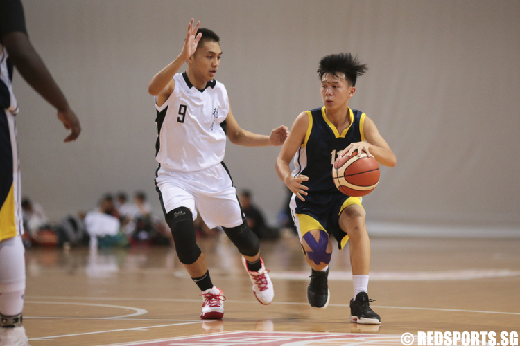 Brendan Lee (#12) of Guang Yang Secondary drives against Israel Liam (#9) of Dunman Secondary. (Photo © Lee Jian Wei/Red Sports)