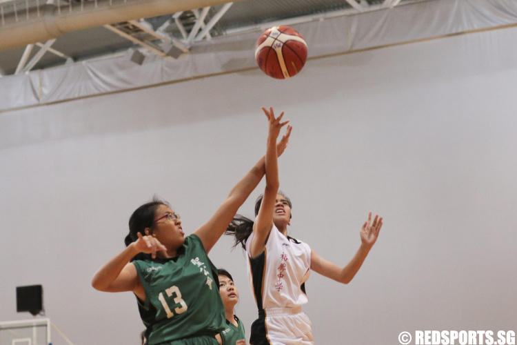 Celine (#4) of Jurong Secondary shoots a layup against Clara Chiang (#13) of Anglican High. (Photo © Lee Jian Wei/Red Sports)