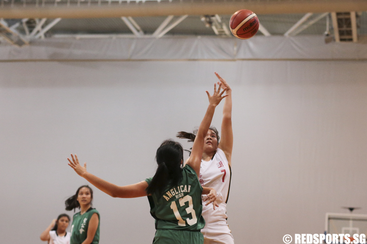 Valerie Lim (#7) of Jurong Secondary shoots a layup against Clara Chiang (#13) of Anglican High. (Photo © Lee Jian Wei/Red Sports)