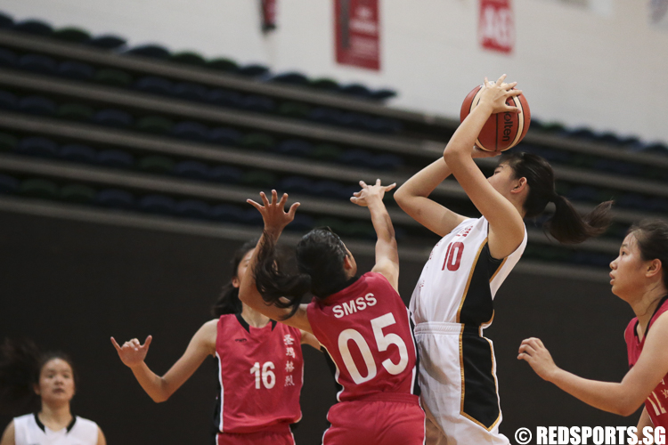 Kindra (#10) of Jurong Secondary shoots against Shanelle Selvakumar (#5) of St. Margaret's Secondary. (Photo © Lee Jian Wei/Red Sports)