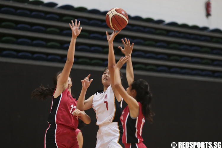 Valerie (#7) of Jurong Secondary shoots against Faith  Koh (#12) and Shanelle Selvakumar (#5) of St. Margaret's Secondary. (Photo © Lee Jian Wei/Red Sports)