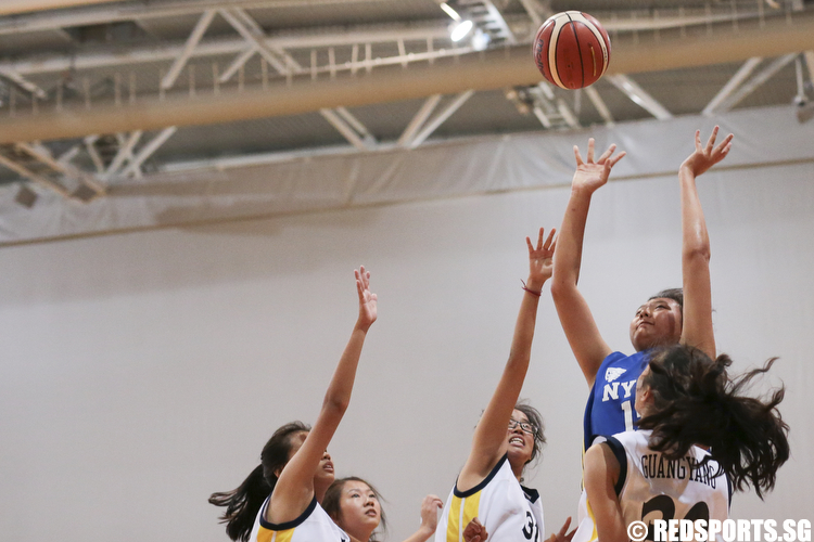 Goh Kung Huang (#15) of Nanyang Girls shoots against Guang Yang Secondary. She scored a game high of 15 points. (Photo © Lee Jian Wei/Red Sports)