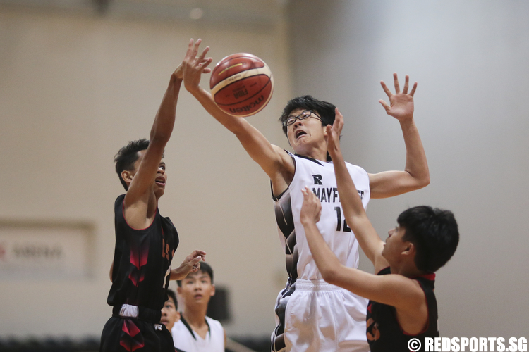 Teng Yan Siak (#12) of Mayflower Secondary shoots a layup against Melvin Chua (#1) and Emmanuel Jude (#11) of Unity Secondary. (Photo © Lee Jian Wei/Red Sports)