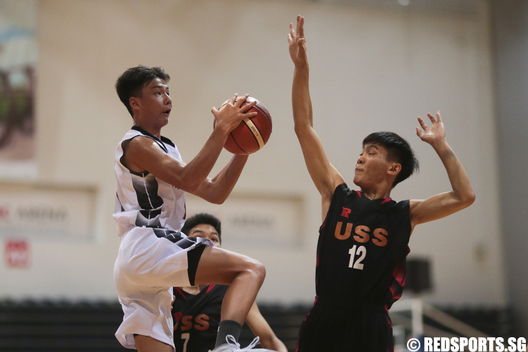 Joshua Kirt (#11) of Mayflower Secondary shoots a layup against Neo Tock Peng (#12) of Unity Secondary. (Photo © Lee Jian Wei/Red Sports)