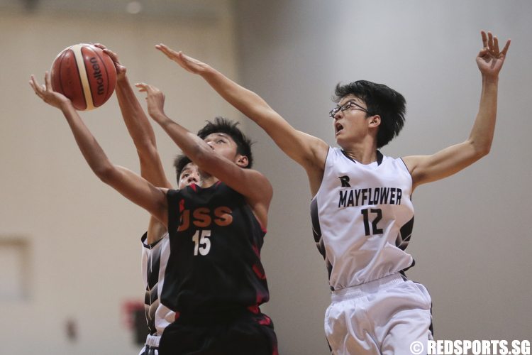 Nurhairie Nazief (#15) of Unity Secondary goes for the layup against Teng Yan Siak (#12) of Mayflower Secondary. (Photo © Lee Jian Wei/Red Sports)