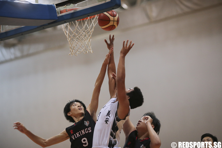 Markus Maran (#33) of Ngee Ann Secondary fights for the rebound against Dillon Ong (#9) and Arnald Foo (#10) of North Vista Secondary. (Photo © Lee Jian Wei/Red Sports)