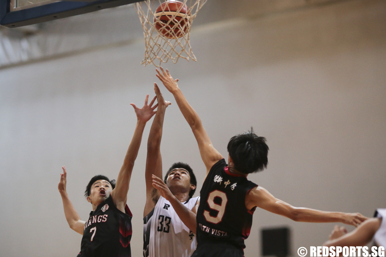 Markus Maran (#33) of Ngee Ann Secondary shoots a layup against Amos Tai (#7) and Dillion Ong (#9) of North Vista Secondary. (Photo © Lee Jian Wei/Red Sports)