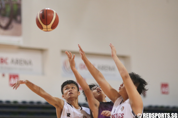 Kelvin Seet (#17) of Jurong West Secondary fights for the rebound against Damien Yau (#25) and Arnald Foo (#10) of North Vista Secondary. (Photo © Lee Jian Wei/Red Sports)