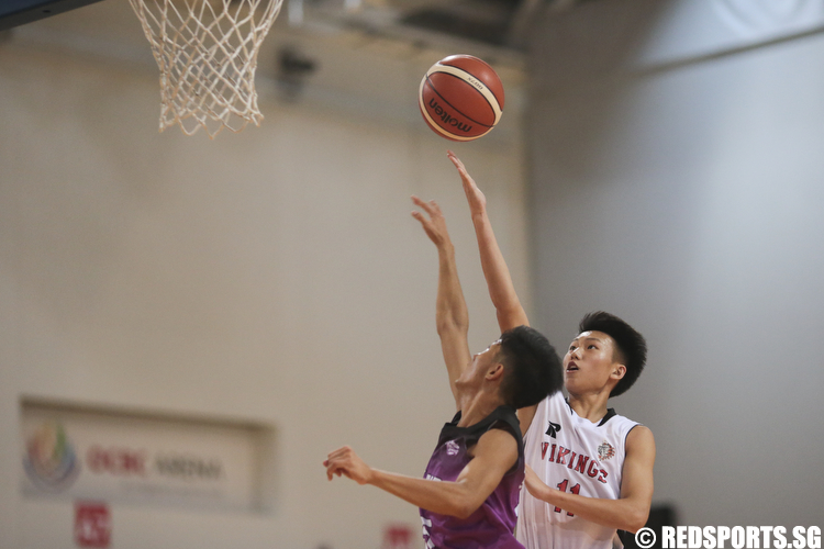 Justen Chiam (#11) of North Vista Secondary shoots a layup against Edric (#15) of Jurong West Secondary. (Photo © Lee Jian Wei/Red Sports)