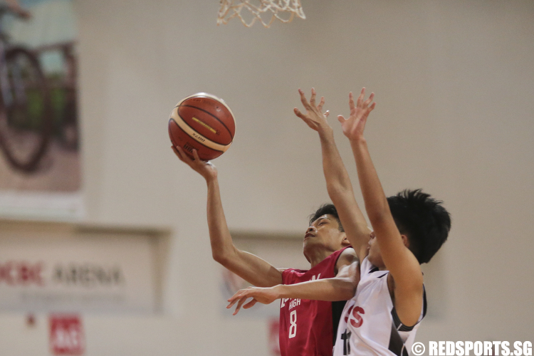 Aaron Tan (#8) of Dunman High shoots a layup against Emmanuel Jude (#11) of Unity Secondary. (Photo © Lee Jian Wei/Red Sports)