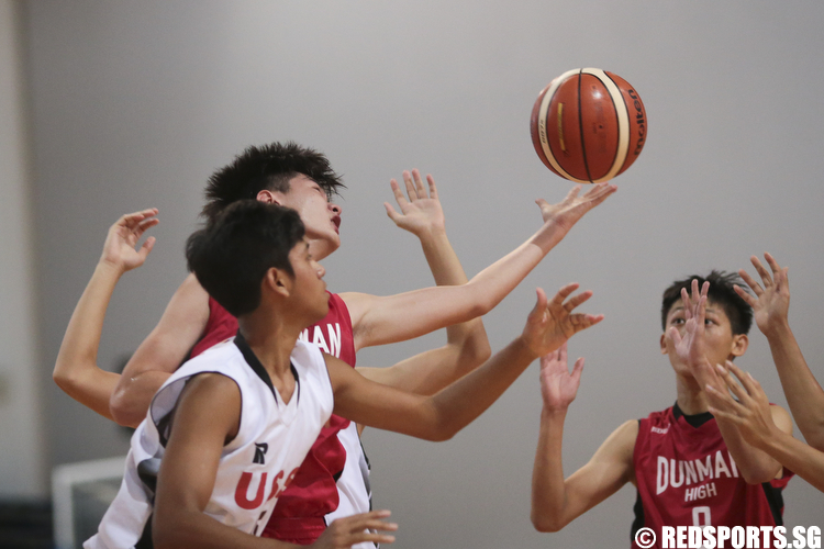 Aiken (#14) of Dunman High and Nurhairie Nazief (#15) of Unity Secondary fights for the rebound. (Photo © Lee Jian Wei/Red Sports)