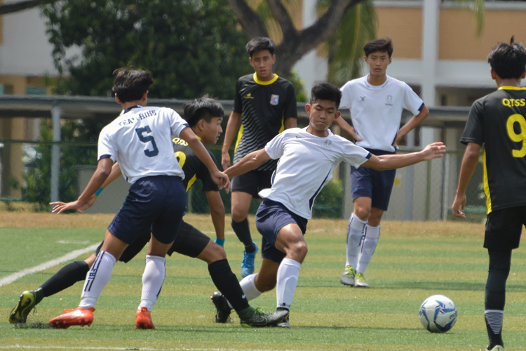 Wayne Lim (QTSS #10) tackles the ball off Ryan Loh (HIHS #6). (Photo 3 © REDintern Nathiyaah Sakhimogan)