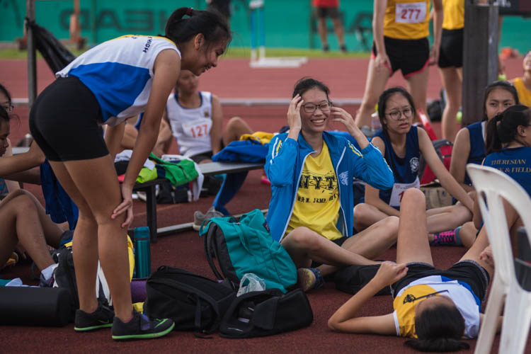 Hu Tianqi (#434) lies on the floor while celebrating her win with her teammates at the B Division GIrls High Jump event. (Photo  © Lee Yu En/Red Sports)