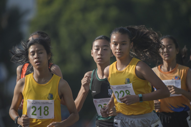 Giselle Diana Enlund (#228) of Cedar Girls' Secondary losing the lead to teammate Amanda Chun (#218) during the 1500m C Division Girls finals. (Photo © Stefanus Ian/Red Sports)