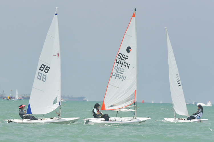 Raffles Institution's Natalia Mai (#5) leading in front of a byte boat and her teammate Marsha Shahrin (#88) during one of their seven races. (Photo © Stefanus Ian/Red Sports)