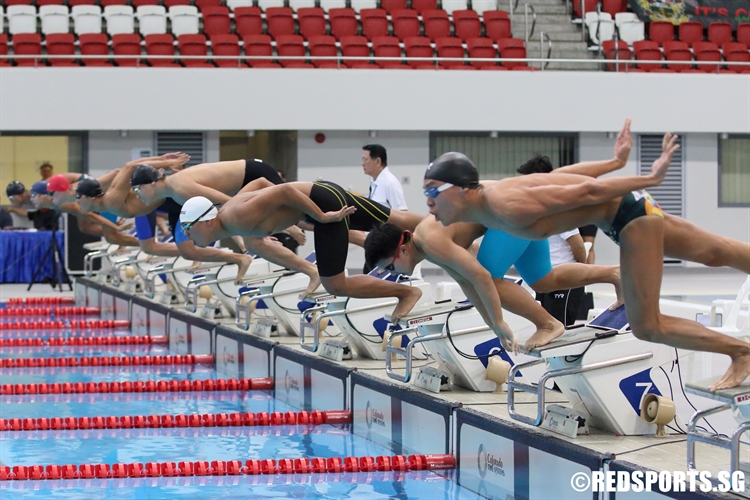 Swimmers diving into the water in the start of the A Division Boys’ 100m Freestyle final. (Photo  © Chan Hua Zheng/Red Sports)