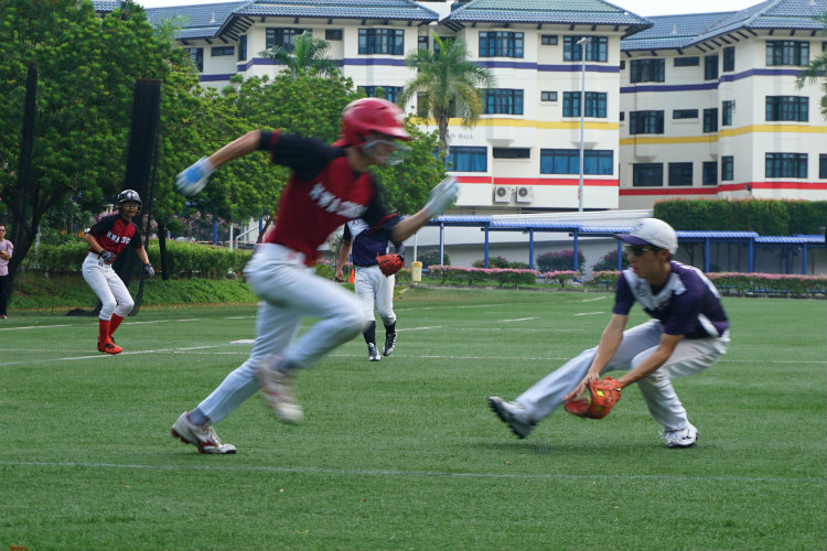 Ryan (ACS(I) #23)(right) fielding the bunt by Anthony (HCI #49)(centre), who assisted Yan Wen (HCI #07)(left) to score. (Photo 3 © REDintern Pang Chin Yee) 