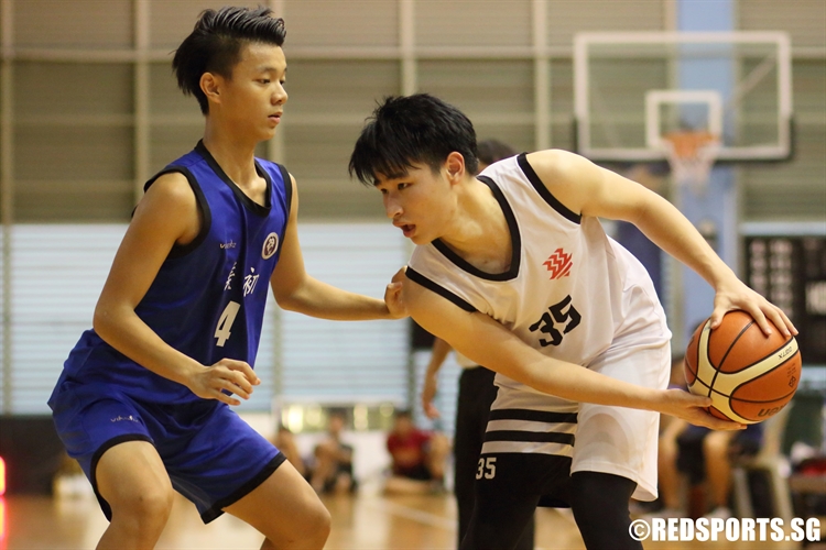 Vernen Lim (HCI #35) sizes up his defender. The HCI guard scored a team-high 15 points, including the game-winning free throw. (Photo 1 © Dylan Chua/Red Sports)