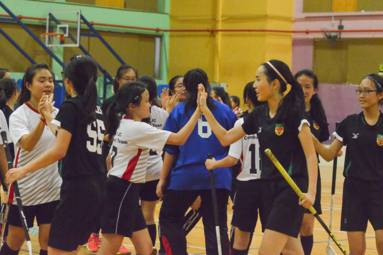 Both teams come together at the end of the match to exchange handshakes. (Photo 1 © REDintern Nathiyaah Sakthimogan)