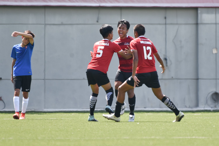 Amrin Taufan (MI #2) celebrating with his teammates after scoring the opening goal of the match. (Photo &copy Stefanus Ian/Red Sports)