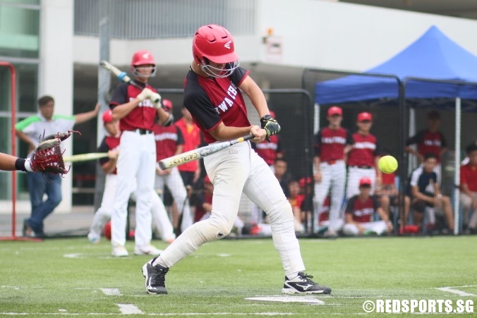 Joshua (HCI #13) swings as he bats against ACSI. (Photo  © Chan Hua Zheng/Red Sports)