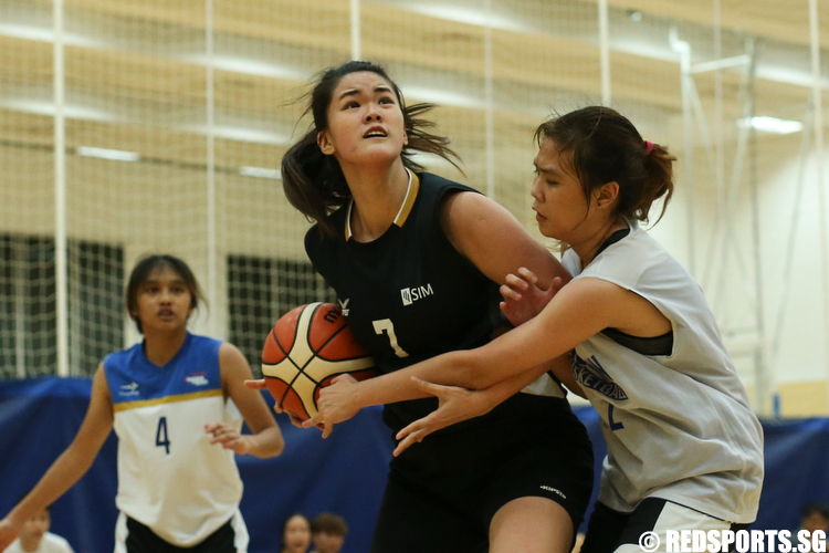 (#7) of Singapore Institute of Management drives the ball against Amelia Wong (#2) of Ngee Ann Polytechnic. (Photo  © Lee Jian Wei/Red Sports)