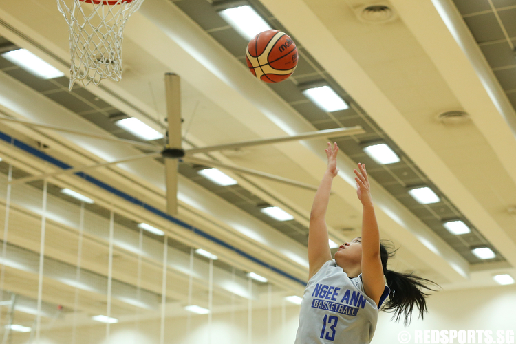 Valentina Wong (#13) of Ngee Ann Polytechnic shoots a layup against Singapore Institute of Management. (Photo © Lee Jian Wei/Red Sports)