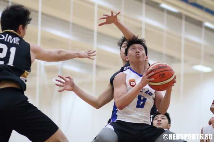 Sia Wei Hng (NP #8) elevates through the defense for a double-clutch lay-up. (Photo  © Chan Hua Zheng/Red Sports)