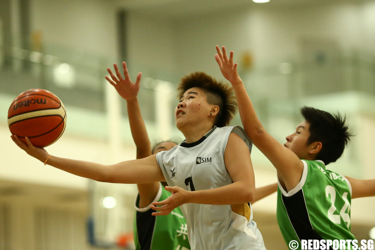 (#7) of Singapore Institute of Management shoots a layup against Desiree Lee (#24) of Republic Polytechnic. (Photo © Lee Jian Wei/Red Sports)