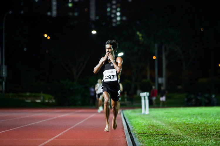 Nabin Parajuli (#297) of SIM celebrates at the end of the men's 10,000m. It is his second gold at this year's IVP Championships after his win in the 5000m. (Photo 1 © REDintern Young Tan)