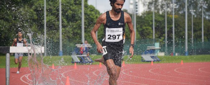 Nabin Parajuli of SIM (#297) going through the water jump during the Men's 3000m Steeplechase race. He clinched gold with a time of 9:44.04. (Photo 1 © Iman Hashim/Red Sports)