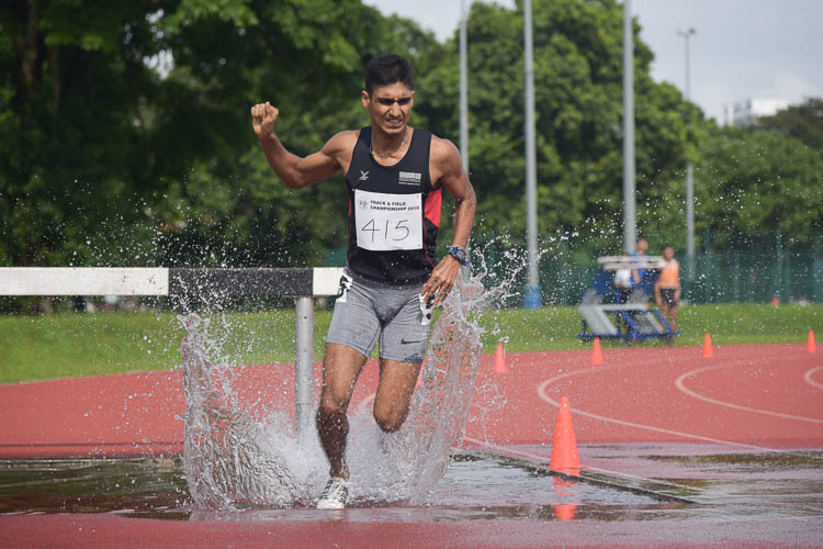 Karthic Harish of SUTD going through the water jump during the Men's 3000m Steeplechase race. He clinched silver with a time of 10:18.99. (Photo 1 © Iman Hashim/Red Sports)