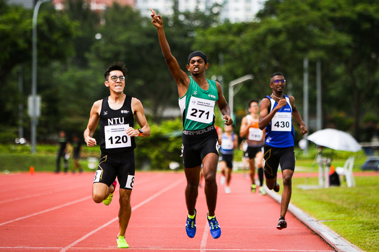 Kiran Raj s/o Suresh celebrating his chest after coming in first in his timed Men's 800m race. He would clinch silver with a time of 2:03.32 (Photo 1 © REDintern Young Tan)