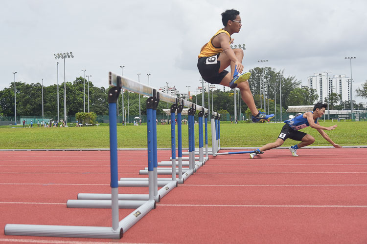 Ervin Teo (in blue) stumbling during the Men's 400m Hurdles race as Lukas Tan (in yellow) jumps over the hurdle. They finished with a time of 1:16.18 and 1:11.51 respectively. (Photo 1 © Iman Hashim/Red Sports)