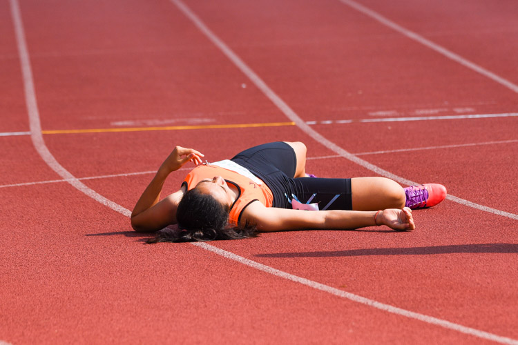 Olivia Sallit of Singapore Sports School collapses to the ground after finishing the race in fourth place. (Photo 8 © Iman Hashim/Red Sports)