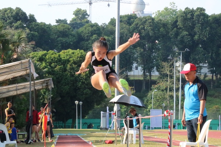 Valencia Ho Ting Yin of Raffles Institution (RI) in action. Valencia placed second overall and was awarded with silver. Her overall distance is 5.32m.