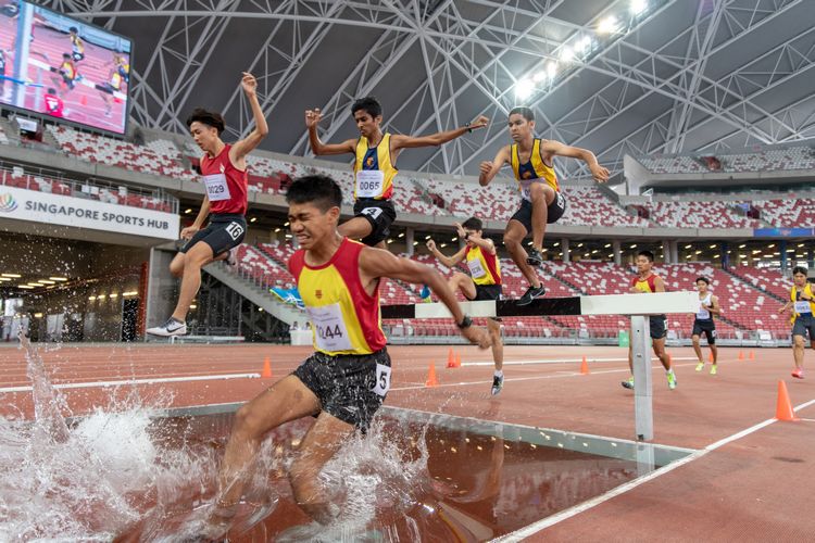 Joshua Rajendran (#244) of HCI sinks into the water during the A Division Boys' 3000m steeplechase final. He went on to finish in second place with a time of 10:36.91.