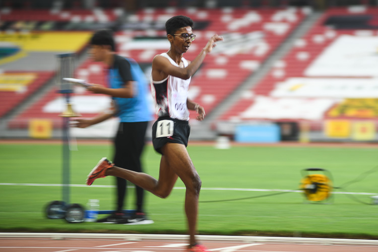 Ruben S/O Loganathan dabbing at the finish line as he finishes first in the A Division Boys' 3000 metres steeplechase race. (Photo 1 © Stefanus Ian/Red Sports)