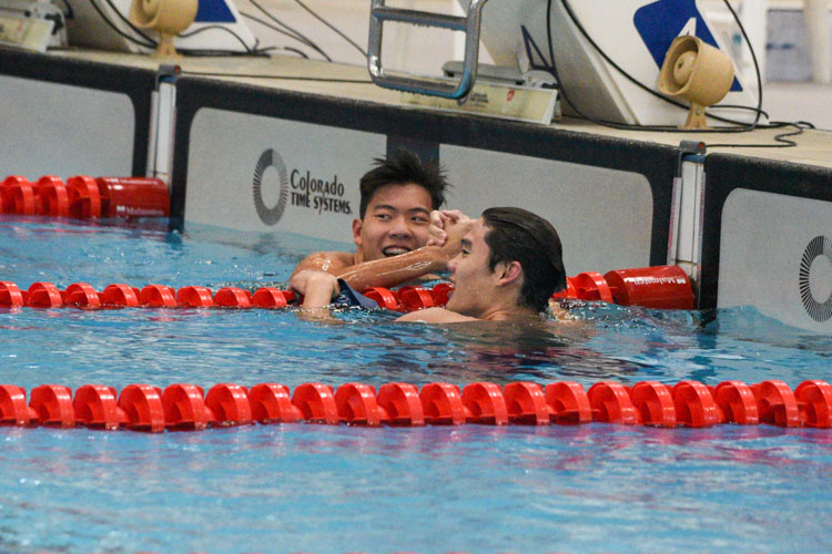 ACS(I)'s Bertrand Cher (left) shares a moment with teammate Isaac Pang after winning the A Division boys' 200m Backstroke final in 2:12.80. (Photo 1 © Iman Hashim/Red Sports)