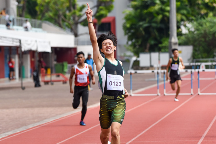 Matz Chan (#123) of RI celebrating as he crossed the finish line in the A Division boys' 400m hurdles final. He finished first in 57.25 seconds. (Photo 1 © Iman Hashim/Red Sports)