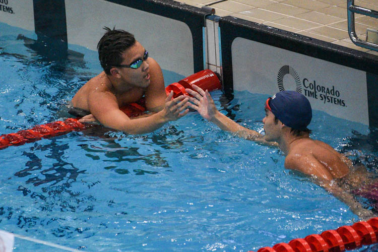 Mikkel Lee of ACS(I) shaking hands with his competitior after the A Division boys' 50m backstroke final. (Photo 1 © Iman Hashim/Red Sports)
