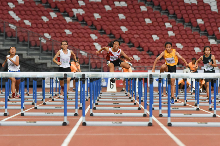 Hayley Lim (#705, middle) of NJC clears a hurdle. She finished second in the C Division girls' 80m hurdles final with a time of 13.11s. (Photo X © Iman Hashim/Red Sports)